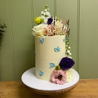 6” double barrel with added fresh flowers, happy birthday topper in a smooth finish