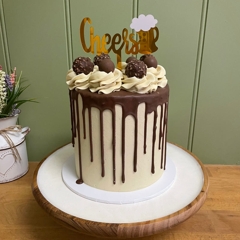 6” extended with ganache drip, custom topper and smooth finish 
